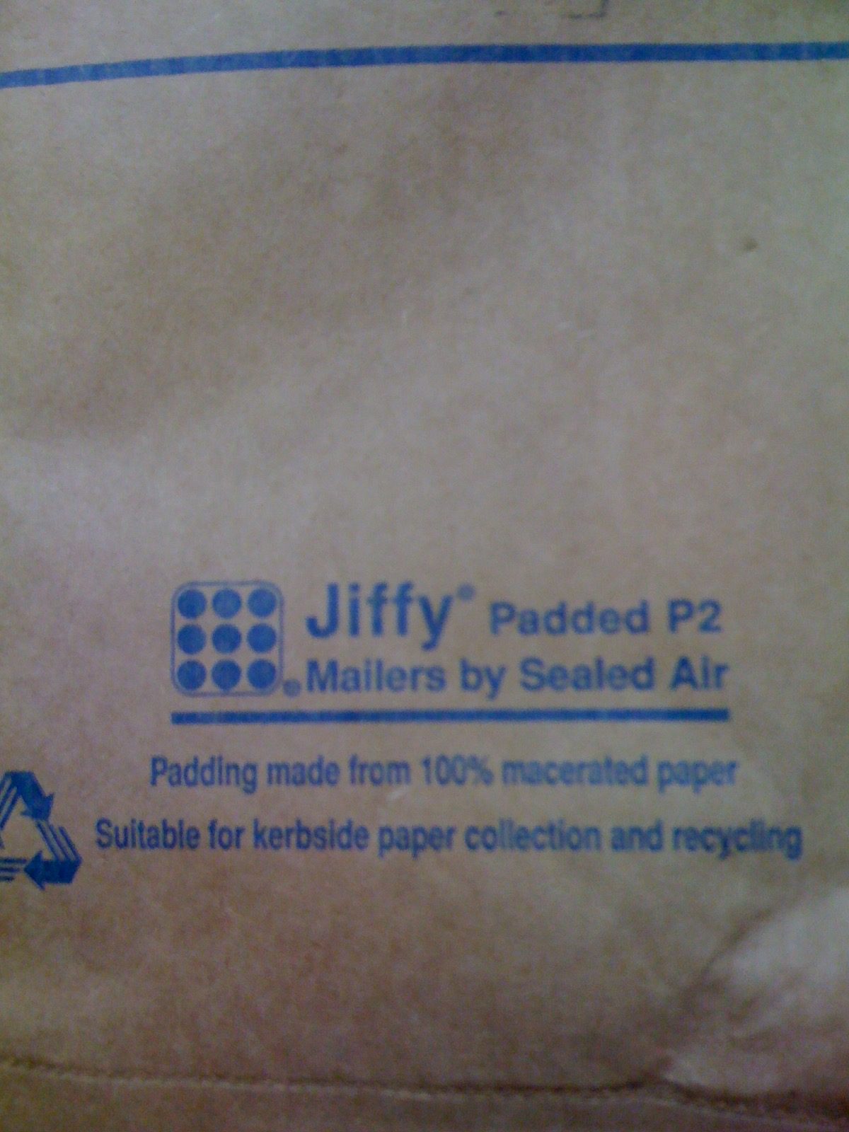 The back of a packing envelope that indicates it has padding that contains 100% macerated paper, whatever that is